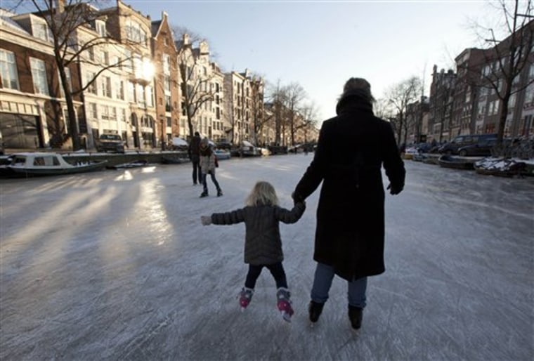 Skaters enjoy a ride on frozen Prinsengracht canal in Amsterdam, Netherlands, on Monday.